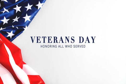 Veterans day. Honoring all who served. American flag on gray background with copy space.