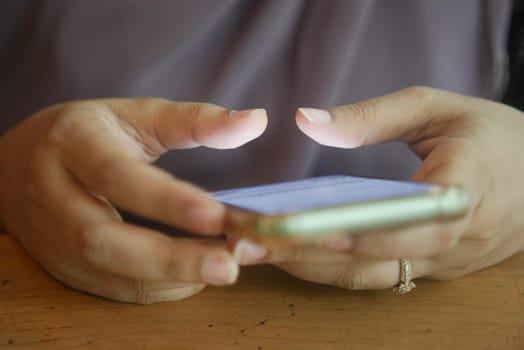 close up of women hand holding smart phone.