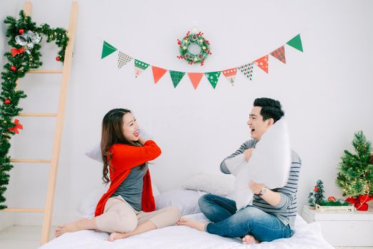 Christmas. Asian Couple at home celebrating New Year.