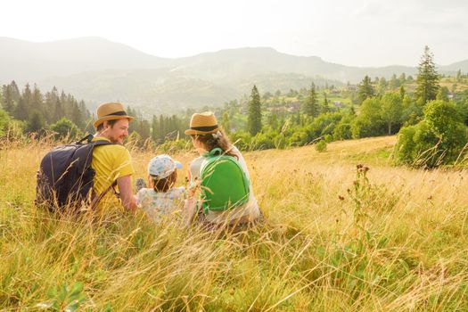 Active summer holiday lifestyle travel mountain family vacation. Children hiking mountain vacation travel family holiday kids and parents happy time together. Mountain trip family picnic. Green travel