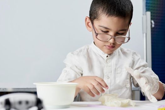 Schoolboy conducting scientific experiments at the workshop