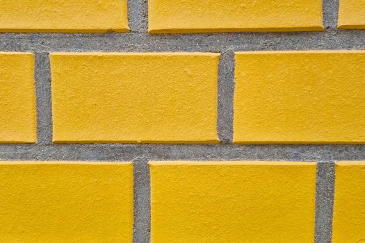 Yellow brick wall of the building, background, concrete texture