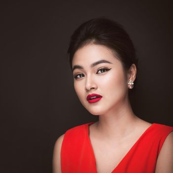 Closeup of beautiful sexy girl with bright makeup and red lips. Beauty fashion asian woman.