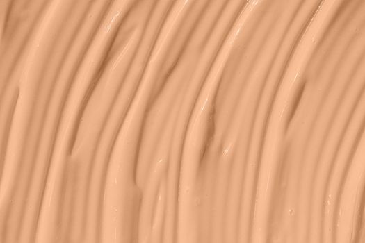 Beige nude liquid foundation texture, concealer smear smudge drop. Make up base, cream textured background. Closeup macro. Cosmetic tonal makeup moisturizer, bb cream swatch sample.