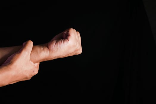 man suffering pain in hand close up .