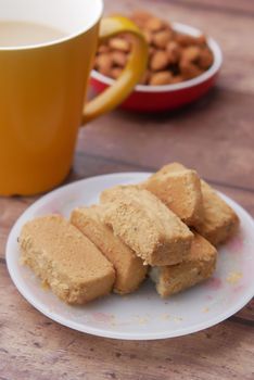 Close up of cookies and tea on table .