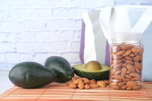 close up of slice of avocado and almond nut on table ,