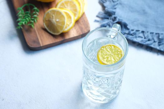 Refreshing lemon water drink on table , top view .
