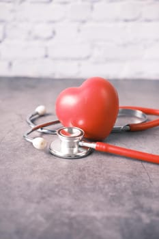 heart shape symbol and stethoscope on table ,