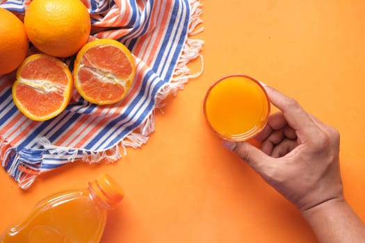 top view of holding a glass of orange juice ,