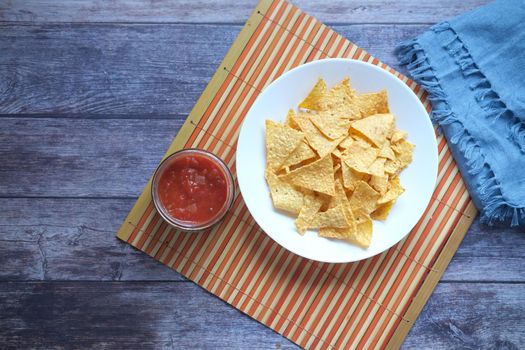 a bowl of chips and salsa on table