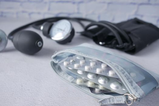 Close up of pills of blister pack in a small bag on blue background .