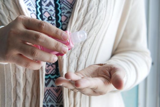 young women using hand sanitizer with copy space .