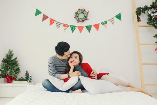 Christmas. Asian Couple at home celebrating New Year.