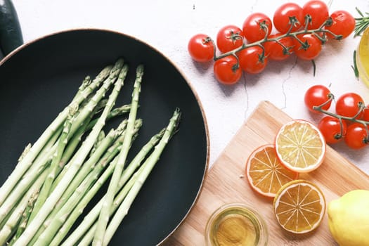 lemon, asparagus, cherry tomato, on table .