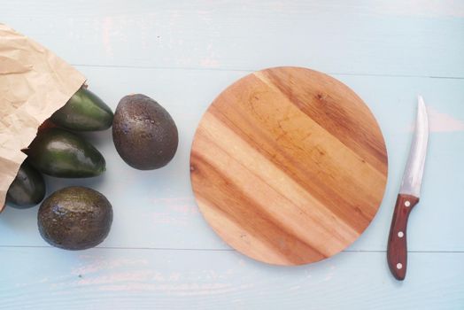 top view of slice of avocado on wooden table ,