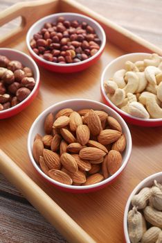 walnut , cashew nut and almond in a container on table .