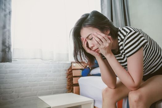 The depression woman sitting alone in the room.