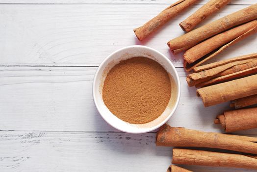 Cinnamon sticks and cinnamon powder on white background