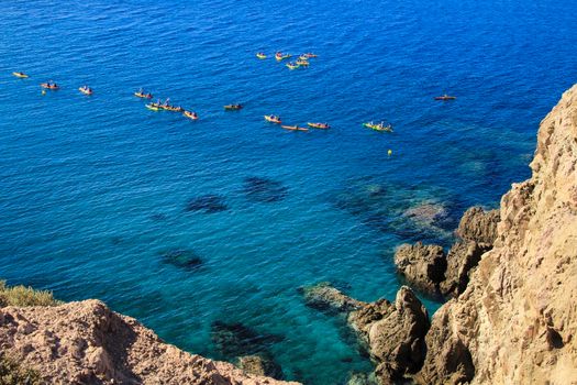 People practicing canoeing in the Reef of the Sirens in Cabo de Gata, Almeria, Spain.