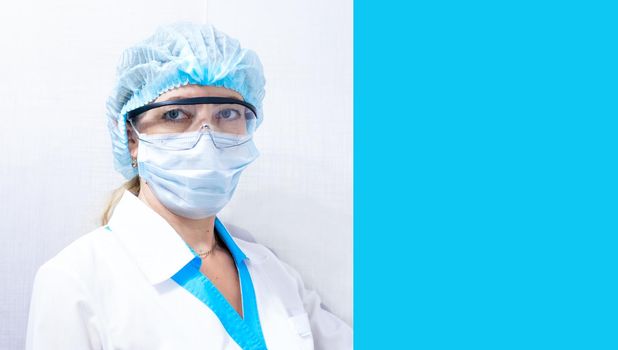 female doctor in medical mask, hat and goggles, blue background on the right for text