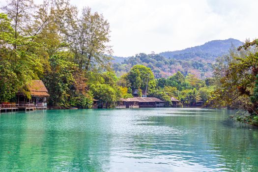 national park of Thailand, houses on the banks of the river in the tropics