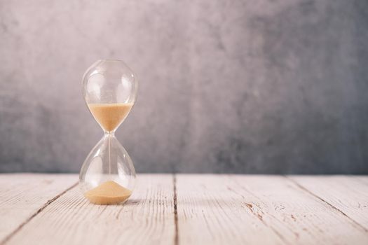 hourglass on table, Sand flowing through the bulb of Sandglass.