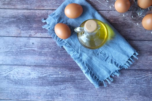 top view of egg and cooking oil in a jar on table ,