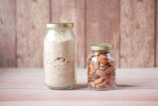 almond powder and almond in a jar on table