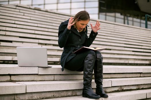 Businesswoman in panic while working outdoor.