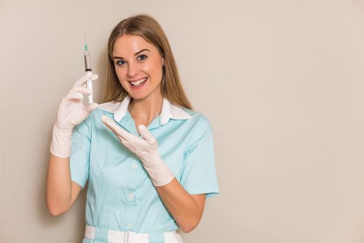 Portrait of medical nurse holding injection.