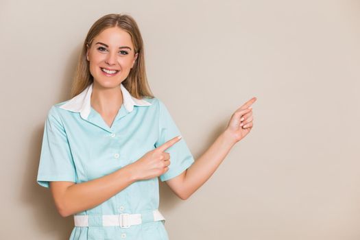 Portrait of medical nurse pointing.
