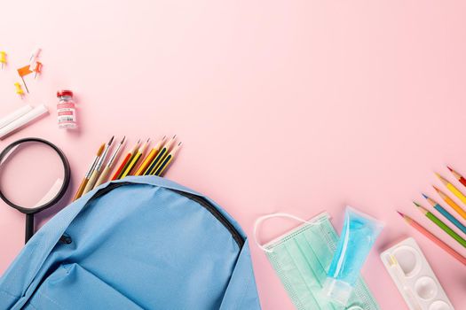 Back to school or college concept. Top view of school supplies stationery, backpack and surgical face mask, isolated on pink background, Back to start education new normal during outbreak coronavirus