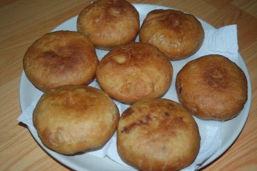 Closeup view of homemade tasty potato bread rolls bun placed over white tissue paper.