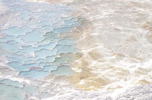 Texture with abstract pattern in pastel colors. Pamukkale calcium travertine in Turkey, top view.