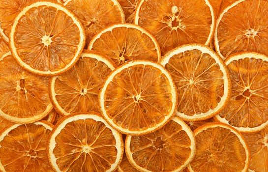 Close up many dried crispy orange ring chips on retail display, elevated top view, directly above