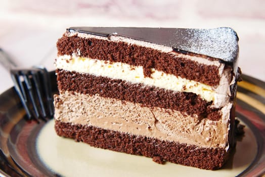 chocolate and cream cake on a plate on table .