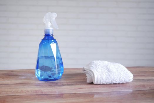 spray bottle and wiping cloth on table ,
