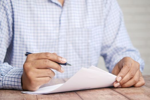 Close up of man hand writing on notepad