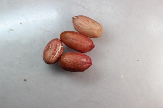 Unpeeled peanut with shells. Food background of peanuts