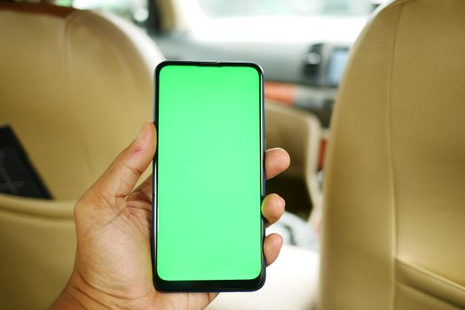 hand holding smart phone with empty screen in a car ,