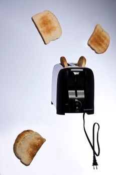 Conceptual product photography of toast popping out of a toaster lightly browned bread creative commercial advertising
