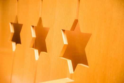 Three Jewish stars carved into wood.