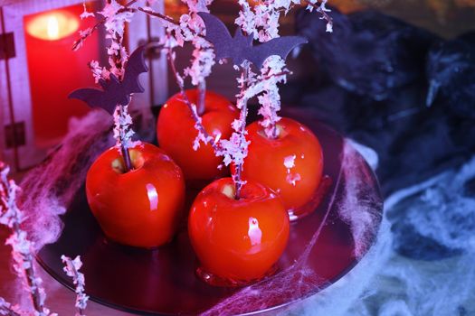 Halloween dessert. Poisoned blood caramelized glazed candy apple. Snow White Poison Lollipops. 