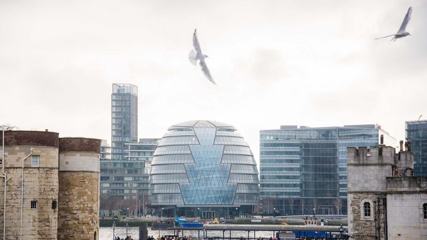 London, UK - January 27, 2017 : Unique view of City Hall in London with birds flying in the foreground.