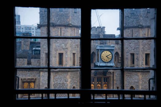 The Tower of London castle clock tower framed within a window view abstract geometric unique angle