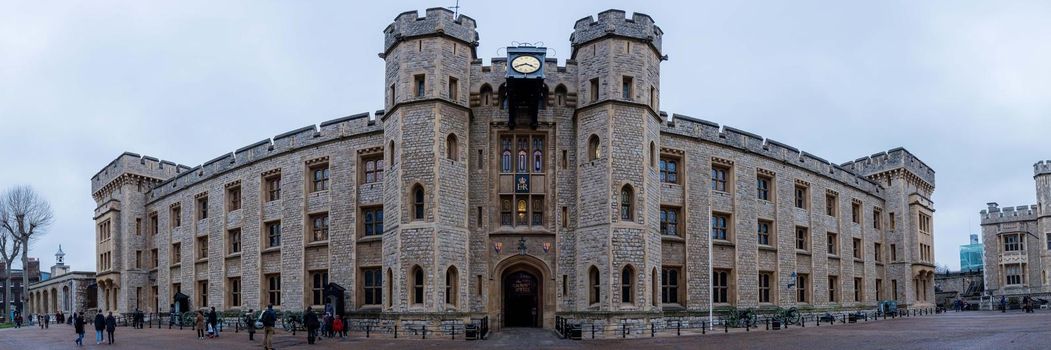 London, UK - January 27, 2017: A panorama of the Tower of London Castle glowing in the evening light.