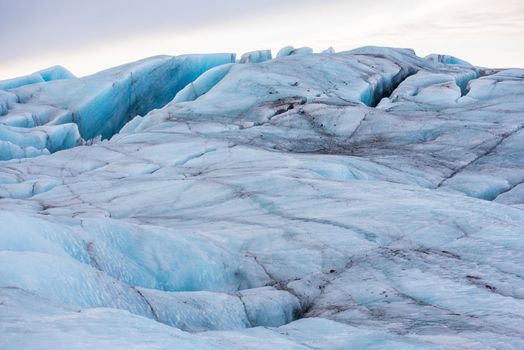 Close up of glacier textured with volcanic ash and blue ice