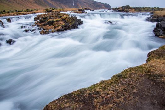 Flowing water and mini waterfalls in landscape long exposure in Iceland