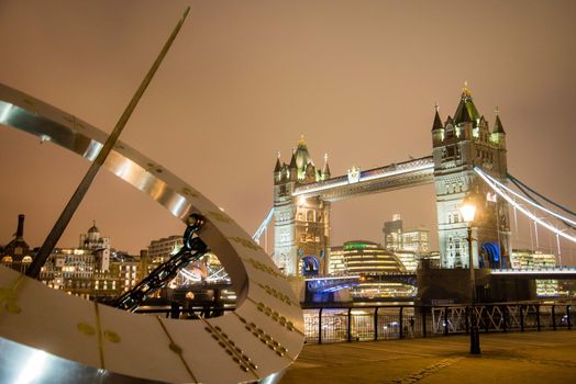 London, UK - January 26, 2017: Juxtaposition of architecture of the Tower Bridge and its compass in London UK
